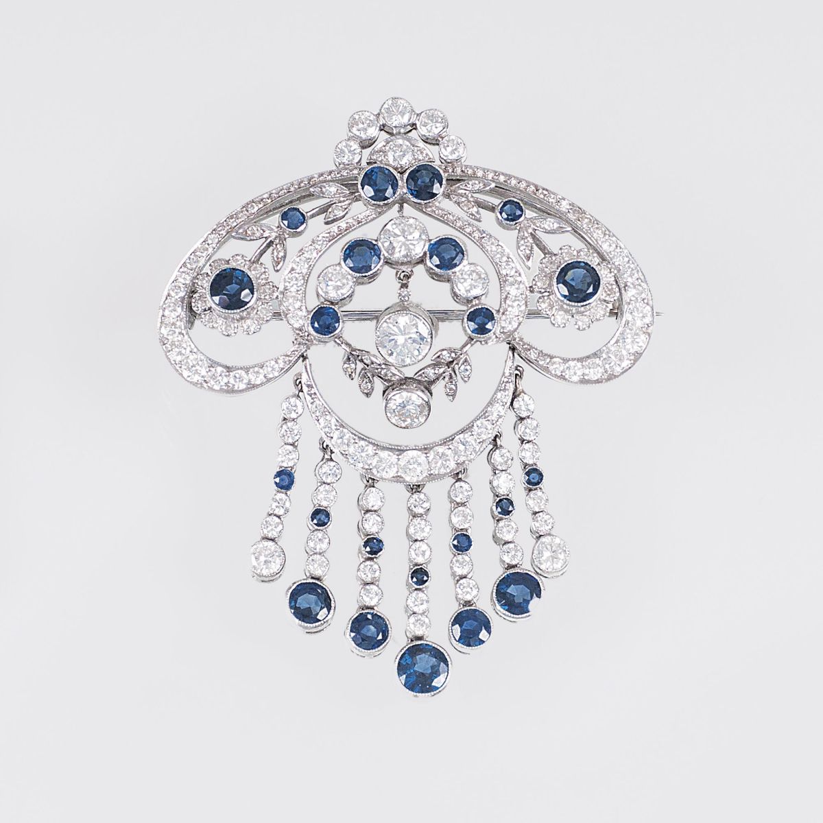 An Art-déco Brooch with Diamonds and Sapphires