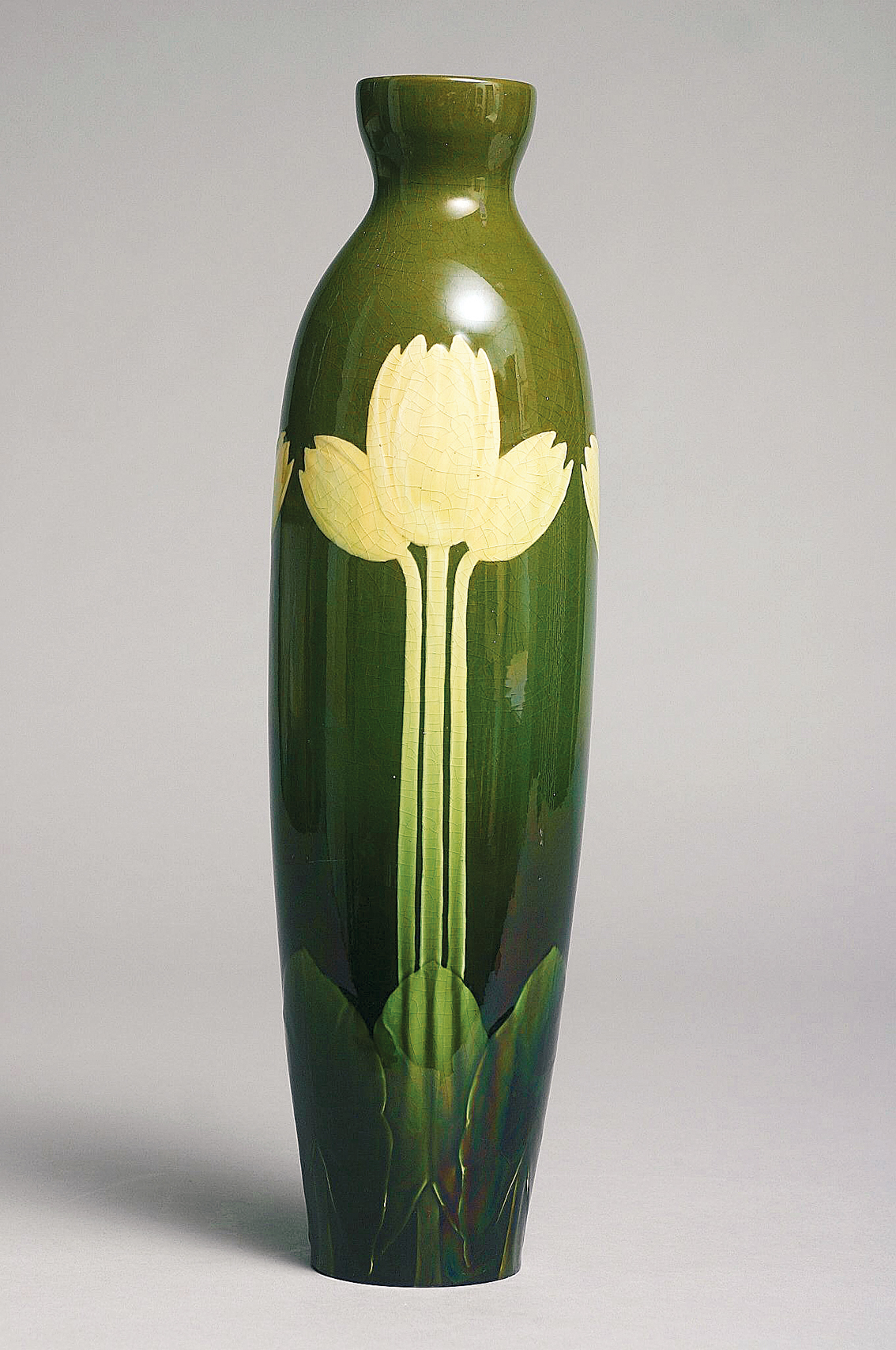 A large art-nouveau green ground vase decorated with tulips