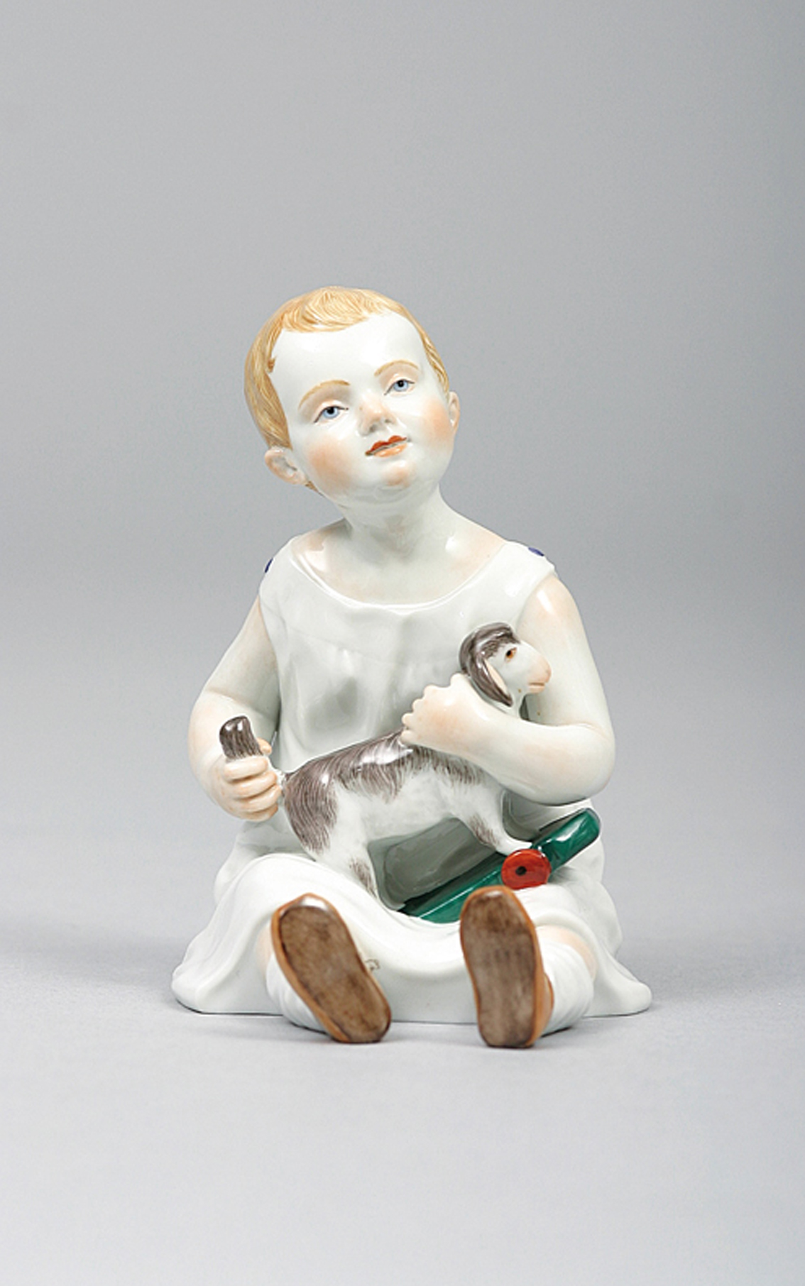 A figure of a Hentschel child 'seated girl wih dog'