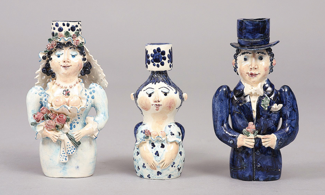 A set of three figure candlesticks 'bridal couple'