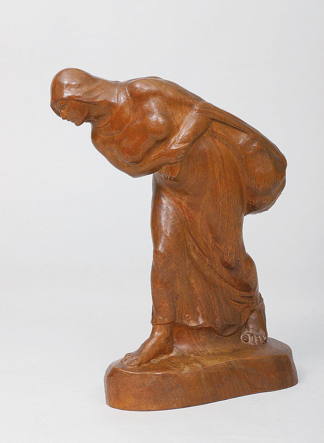 Wooden sculpture 'Peasant bearing a pack'
