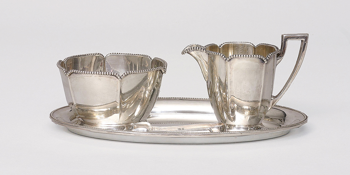 A sugar and cream set with tray