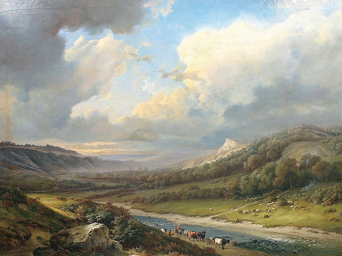 A wide landscape with sheep and cows