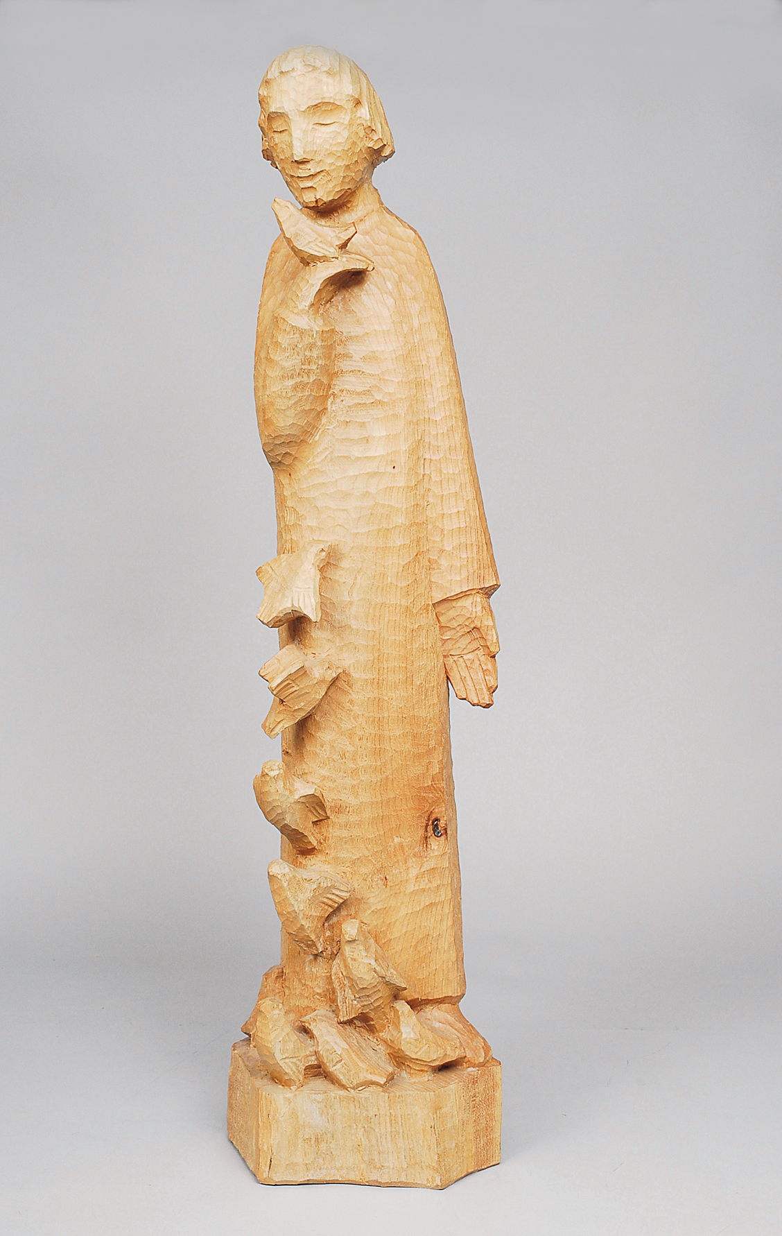 A large wooden sculpture 'male figure with doves'