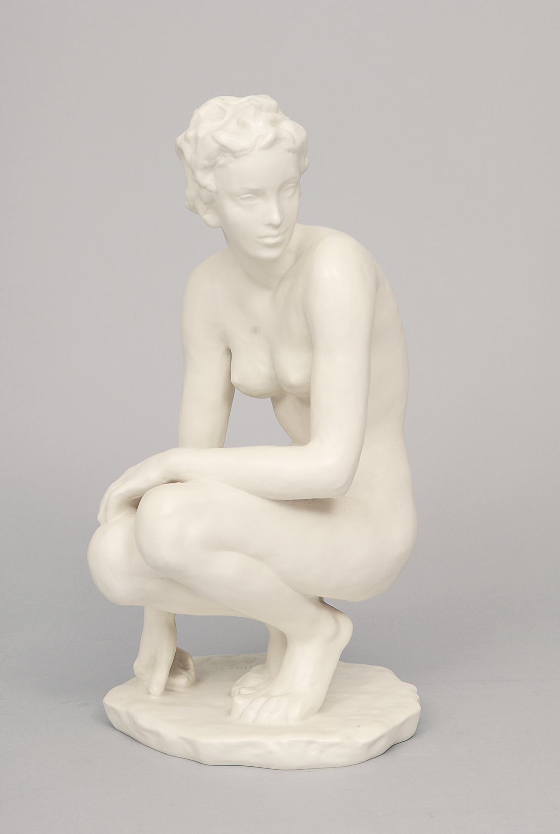 A figure of a crouching nude