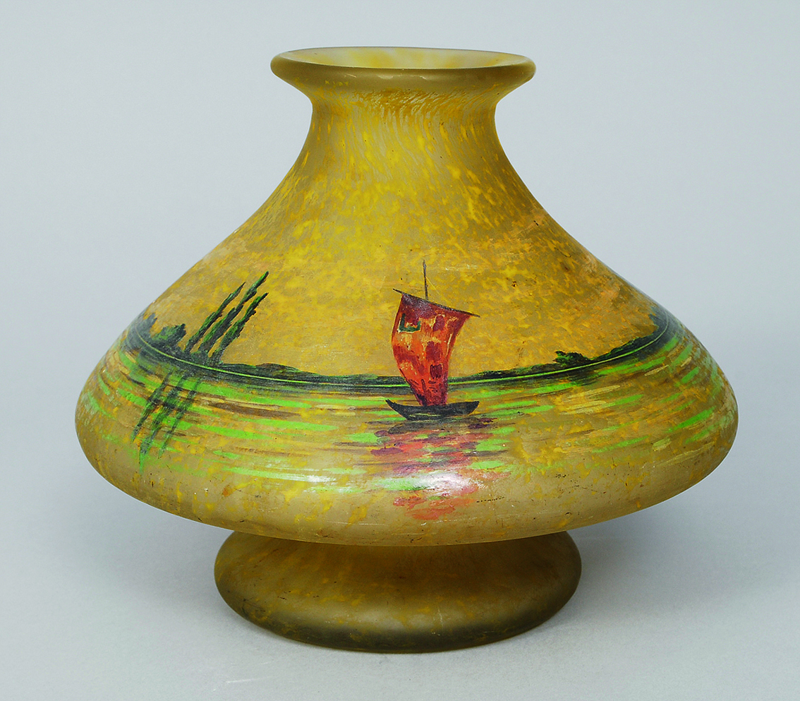 An art nouveau vase with a river landscape