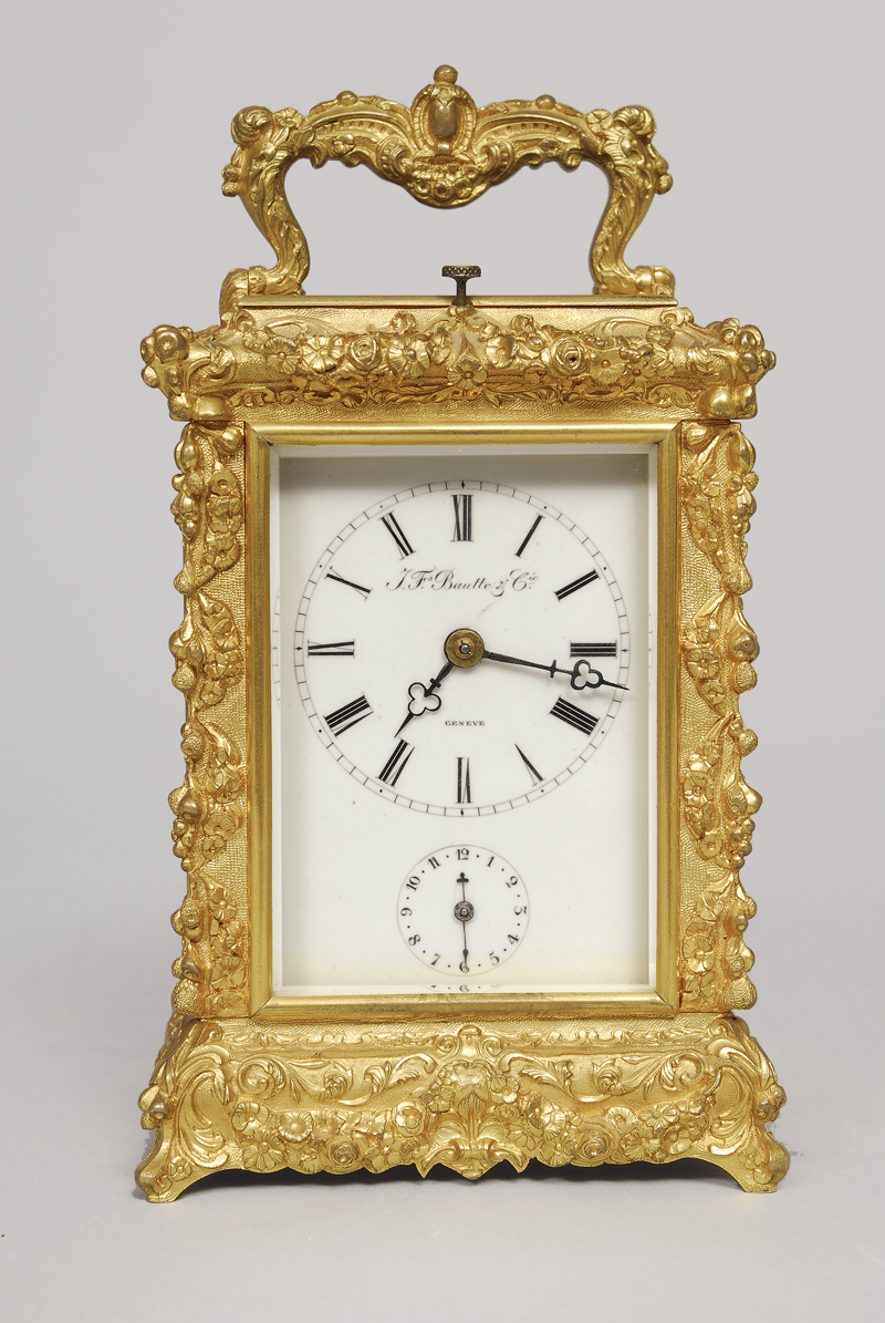 A small bronze carriage clock with foliage ornament