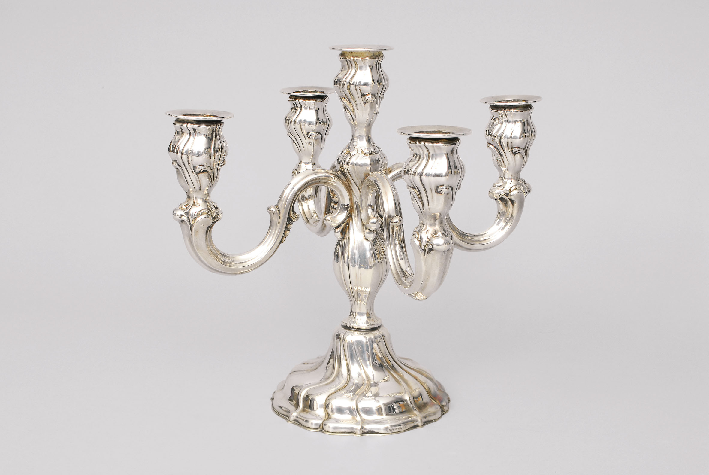 A candle holder in the style of Chippendale