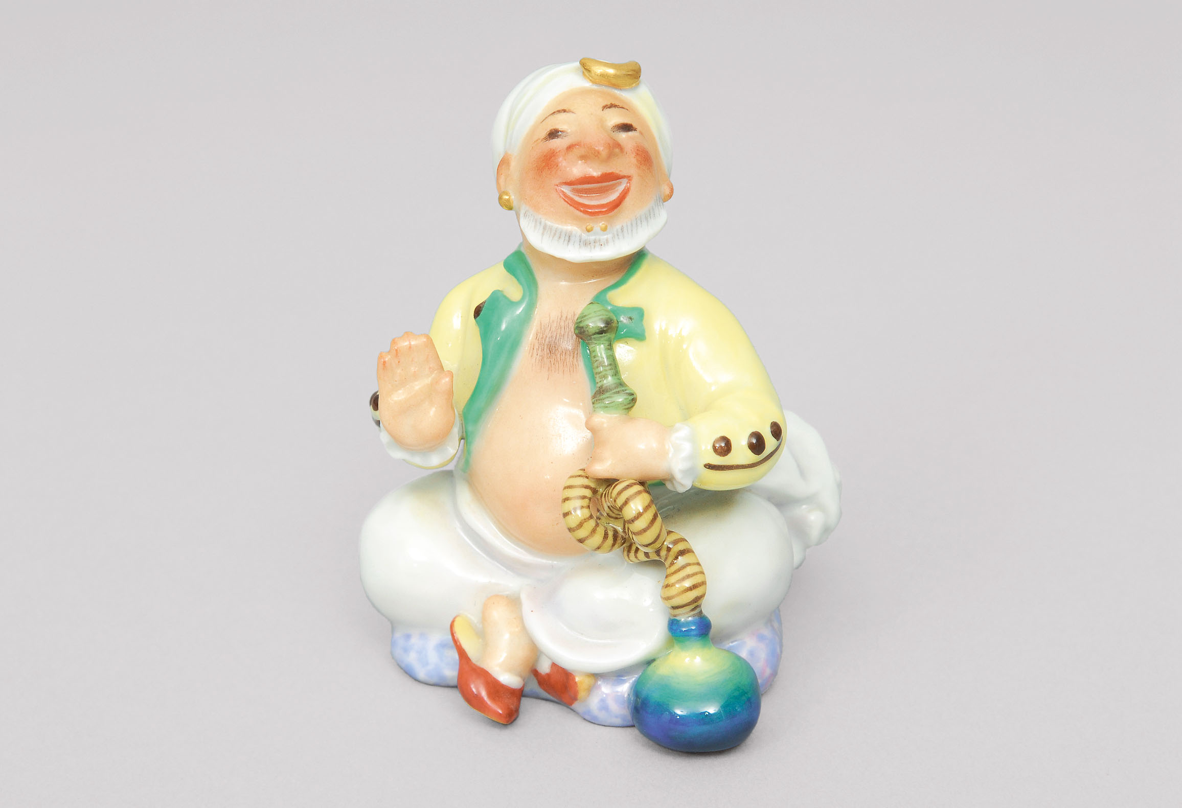 A figurine 'seated turk smoking a hookah'