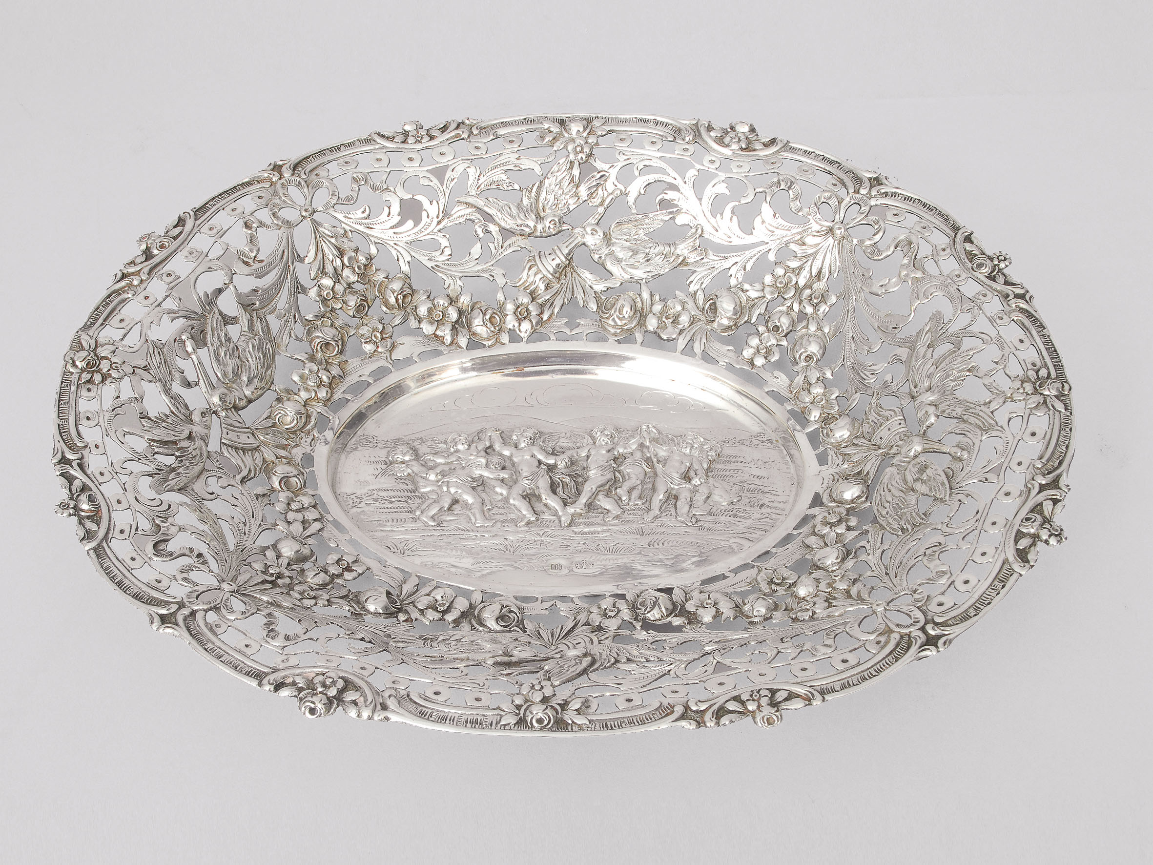 A small bowl with ornaments of dancing putti