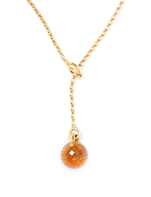 A golden necklace with a citrine pendant