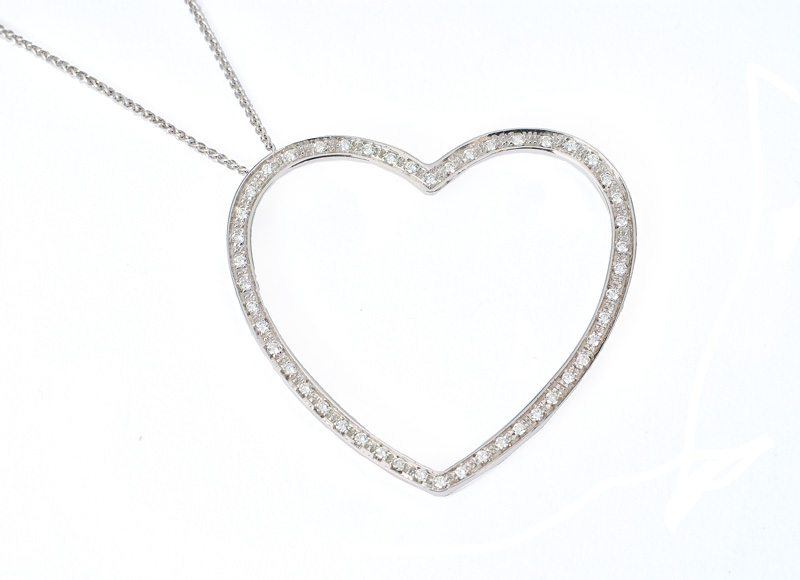 A heart shaped diamond pendant with necklace