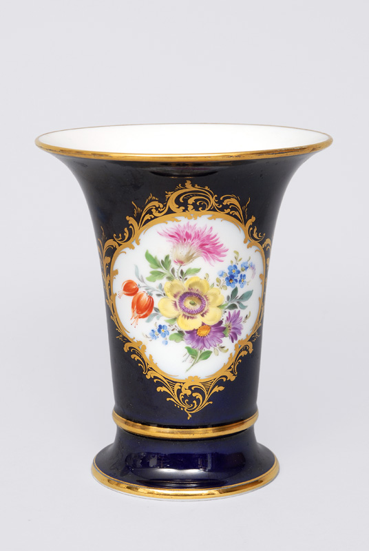 A cobalt blue grounded vase with gilded cartouche within bouquet