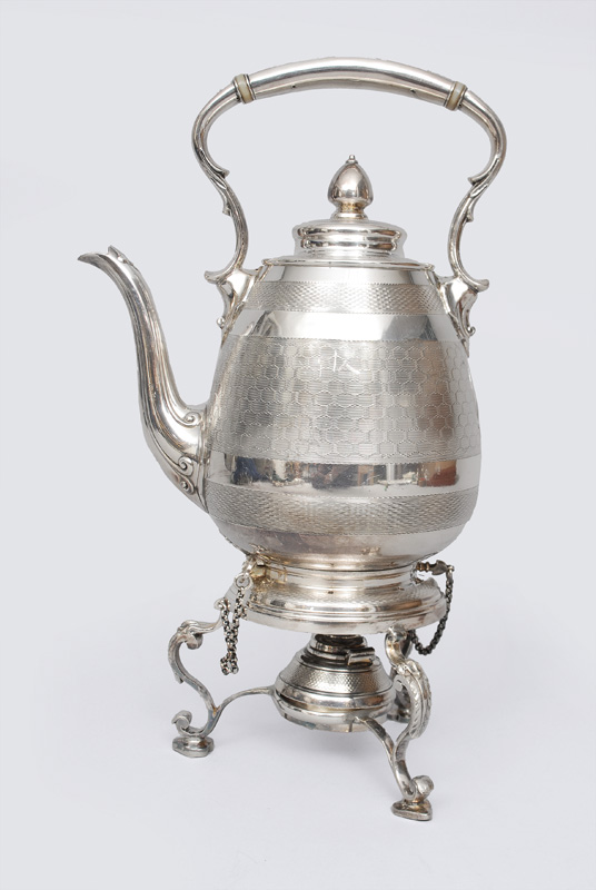 A Victorian teapot with teapot warmer