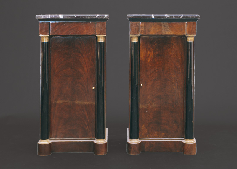A pair of small cabinets with columns