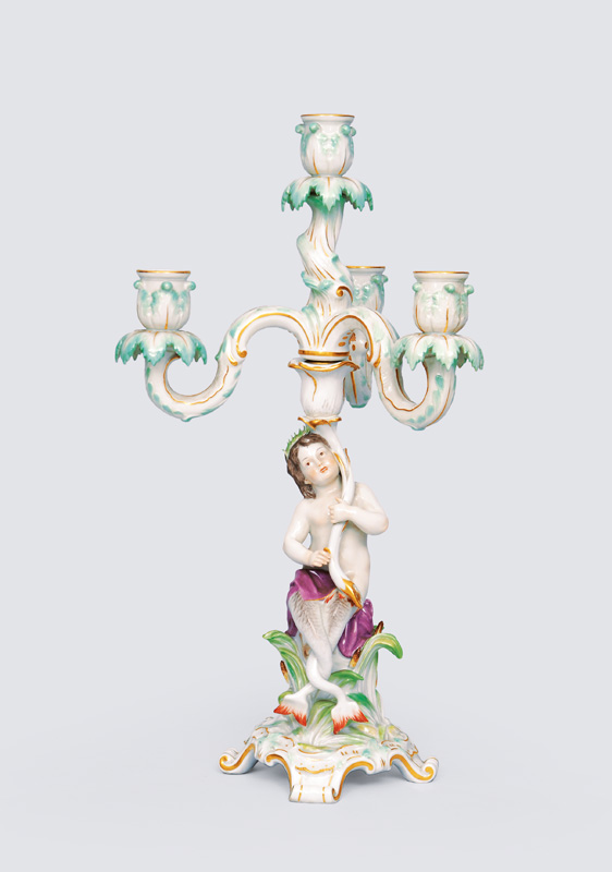 A candlestick with figurine of a mermaid