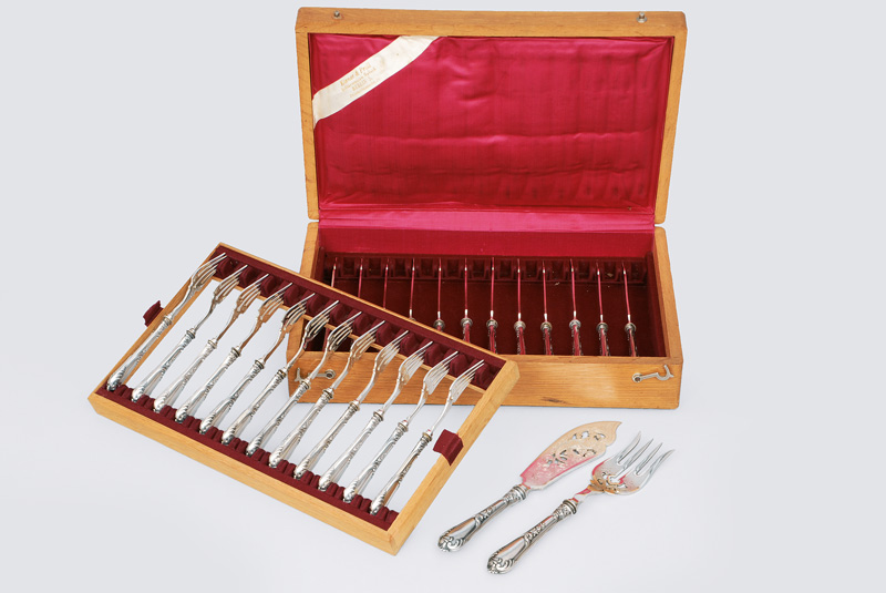 A set of fine graved fish knives and forks for 12 persons