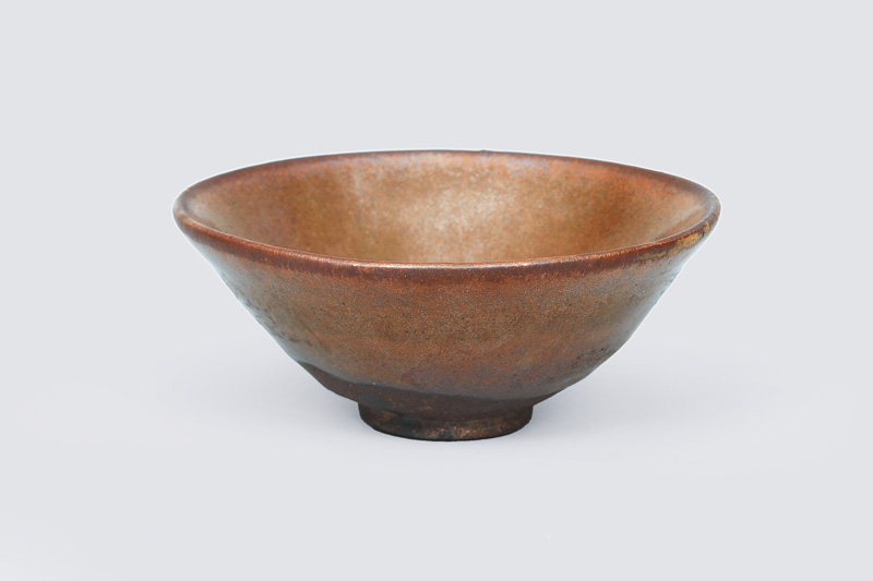 A small bowl with brown celadon glaze