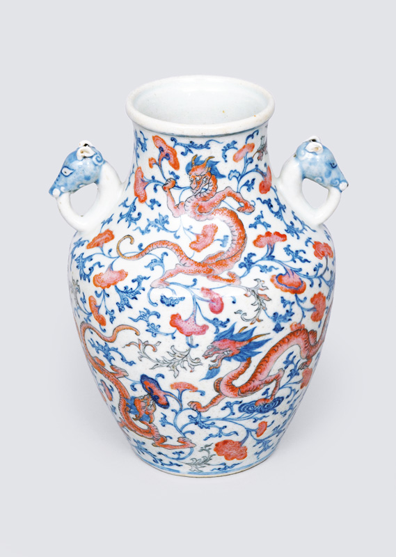 A vase with blue and red dragon pattern
