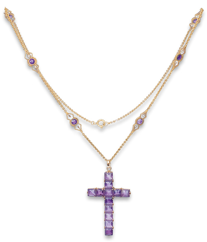 A Georgian amethyst pendant in the shape of a cross with a necklace
