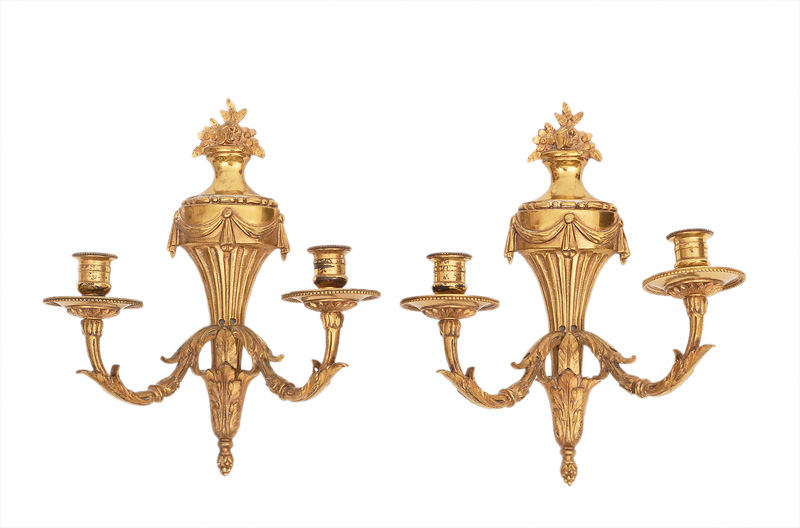 A pair of classical sconces in the shape of a vase