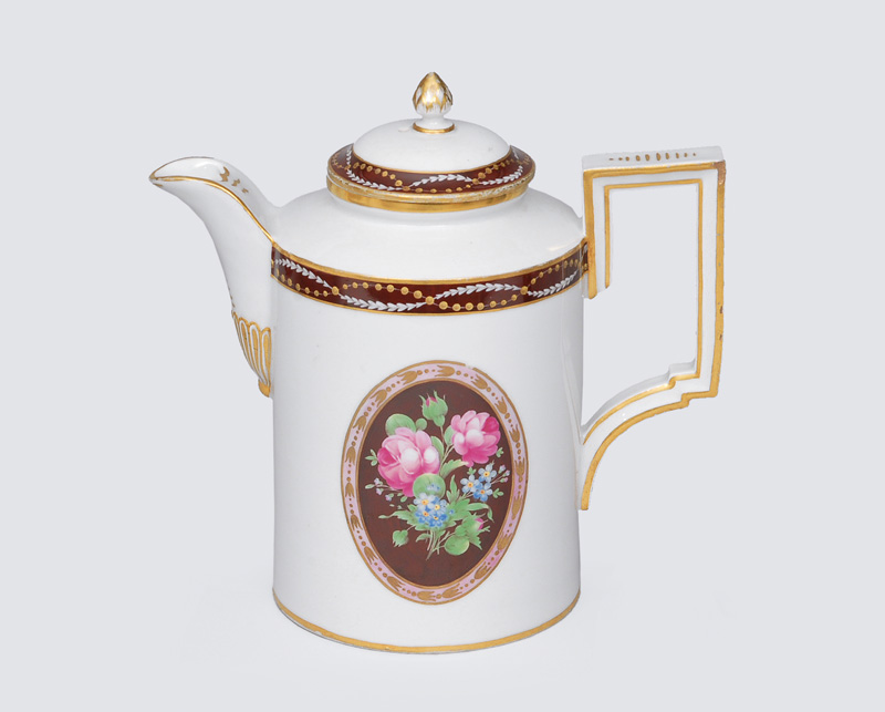 A coffee pot with rose decoration