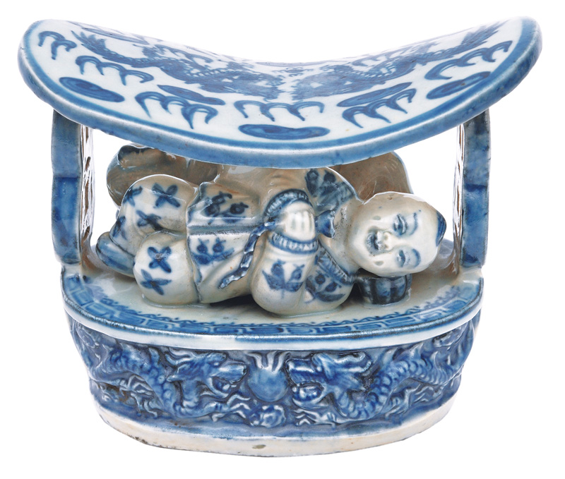 A porcelain neck-rest with blue painting