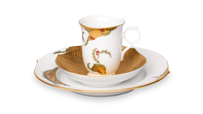 A plate and cup with decoration of holly