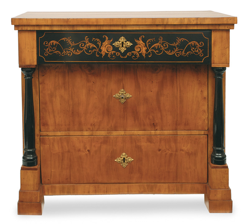 A Biedermeier chest of drawers with black stain painting