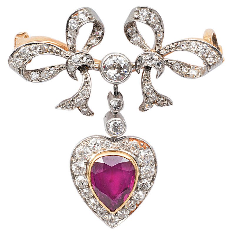 A diamond brooch with a ruby pendant