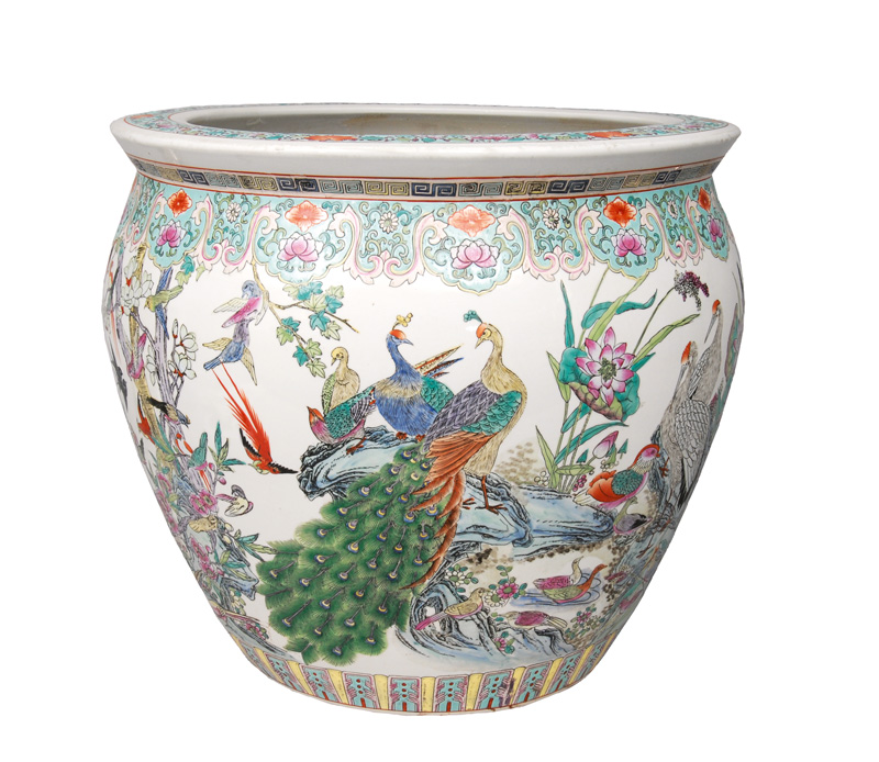 A large goldfish bowl with bird decoration