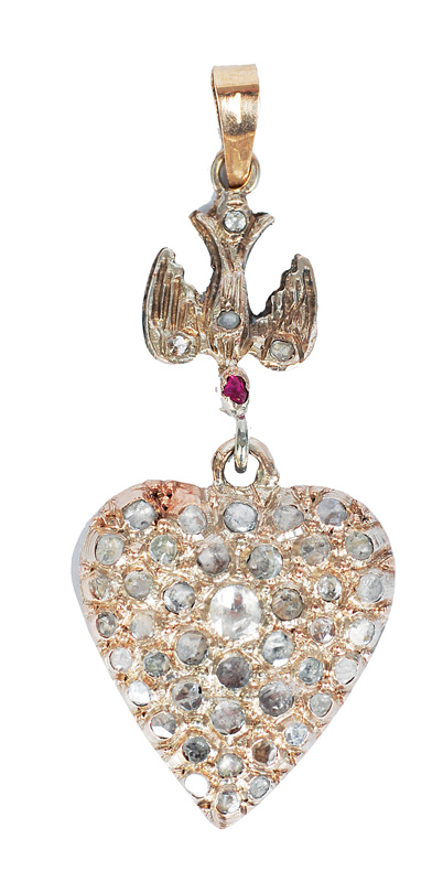 An diamond pendant in the shape of a heart
