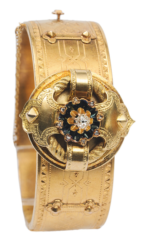 An antique golden bangle bracelet with diamond and enamel