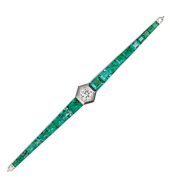 An Art-déco brooch with emeralds and diamonds