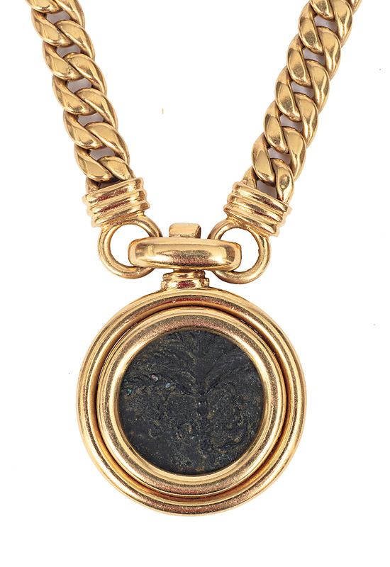 A golden necklace with an antique coin