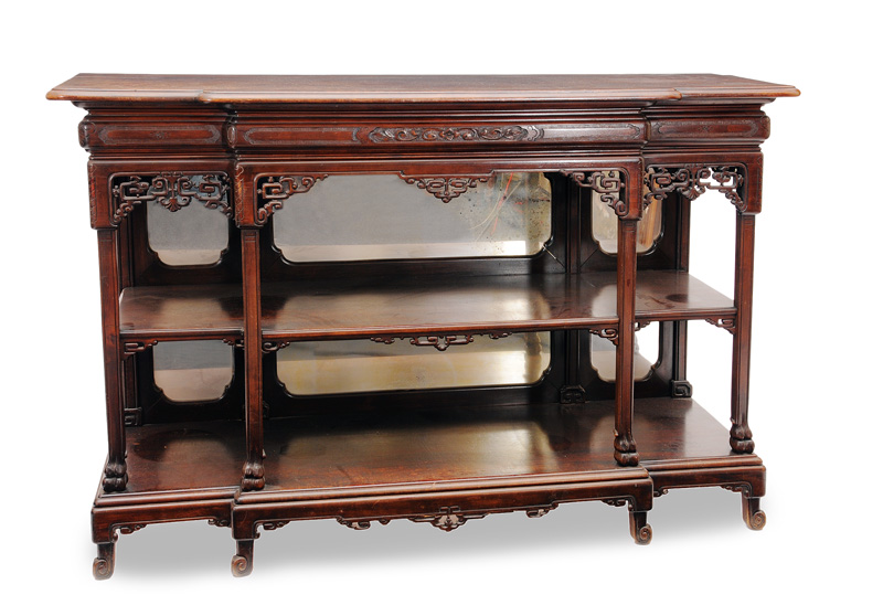 An open cabinet with fretwork