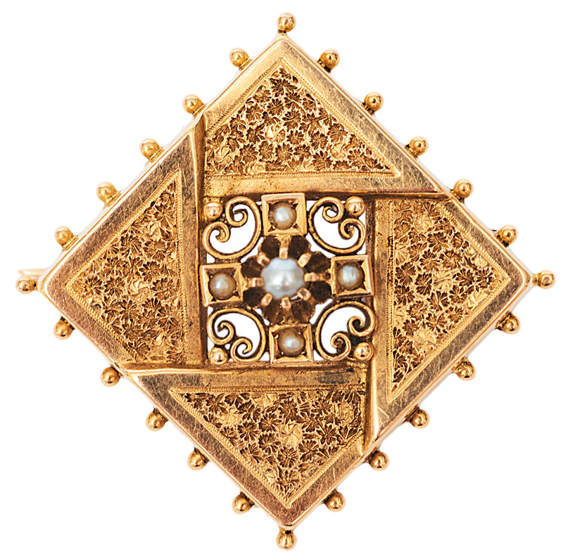 A small antique golden brooch with pearls