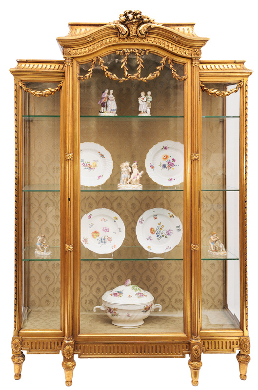 A gildet glass cabinet in the style of Louis Seize