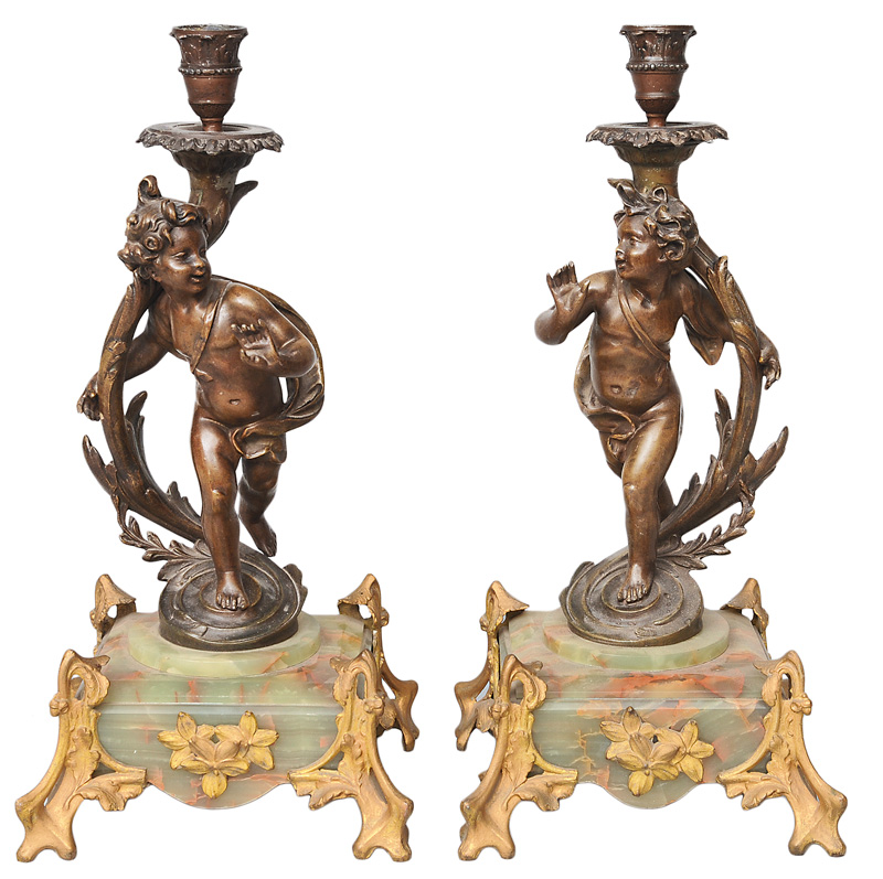 A pair of candlesticks with putto figures