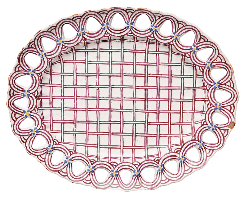 An oval plate with fretwork rim