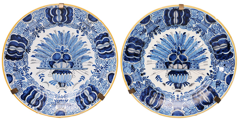A pair of plates with peacock decor