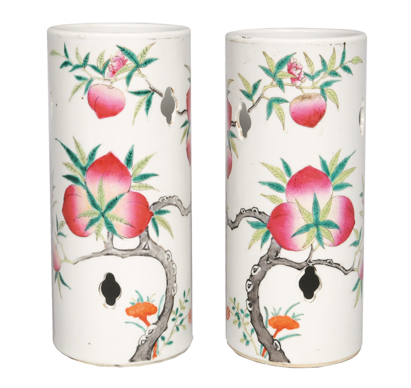A pair of cylindrical vases with peaches