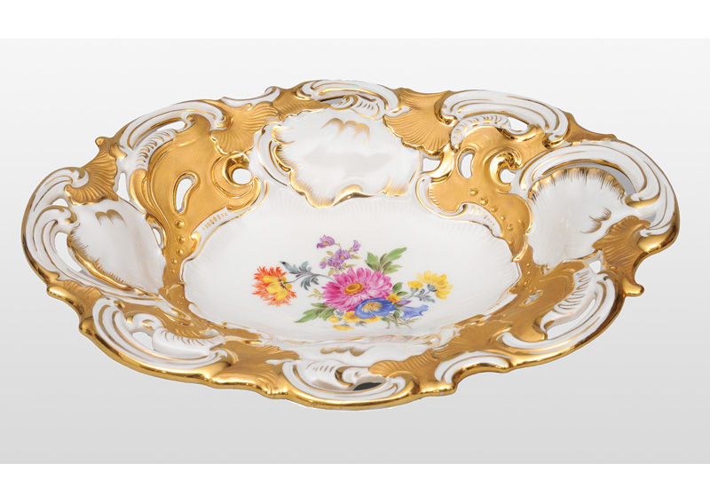 An oval bowl with flower painting and gold decoration