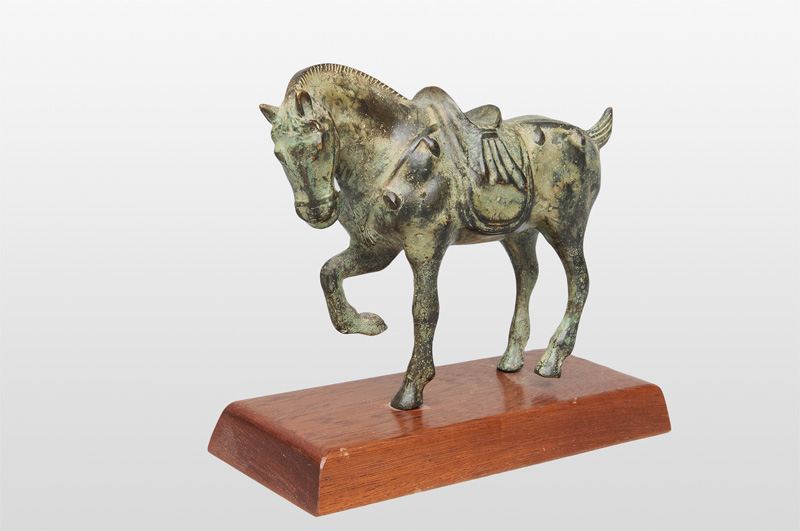 A bronze figurine of a prancing horse