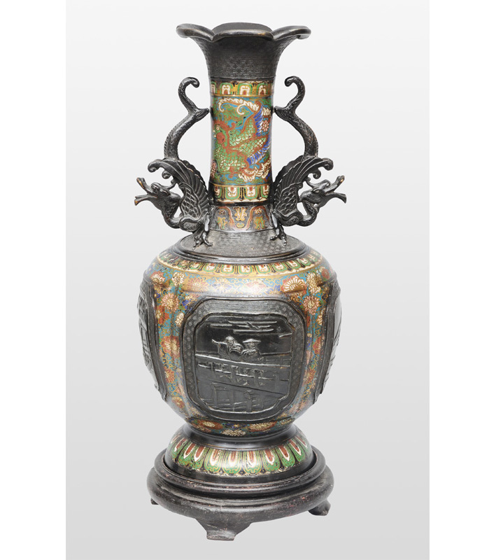 A tall champlevé vase with landscape scenes