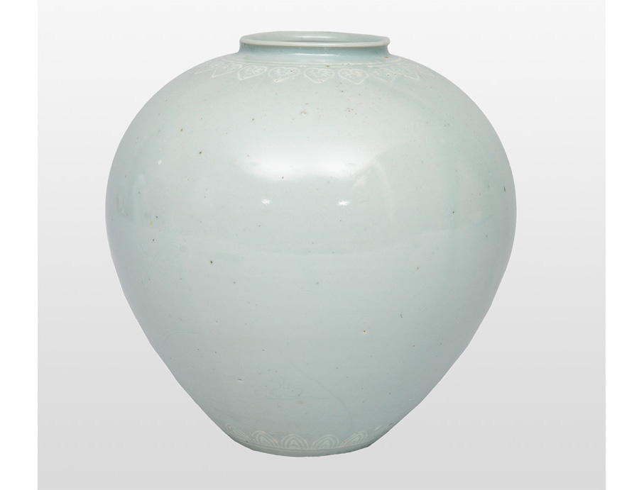A celadon shoulder pot with finely incised decoration