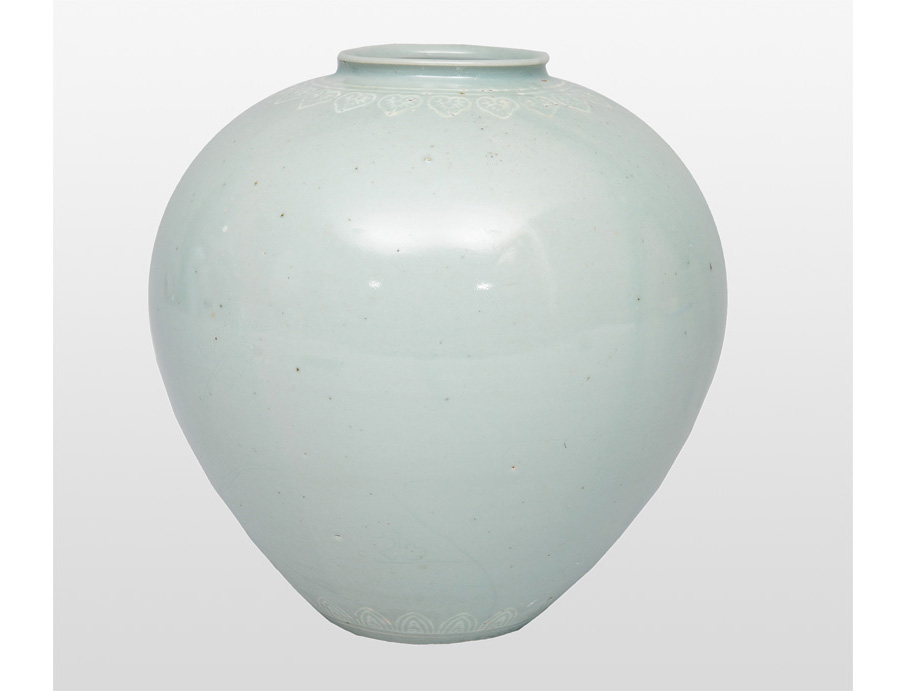 A celadon shoulder pot with finely incised decoration A celadon shoulder pot with finely incised decoration