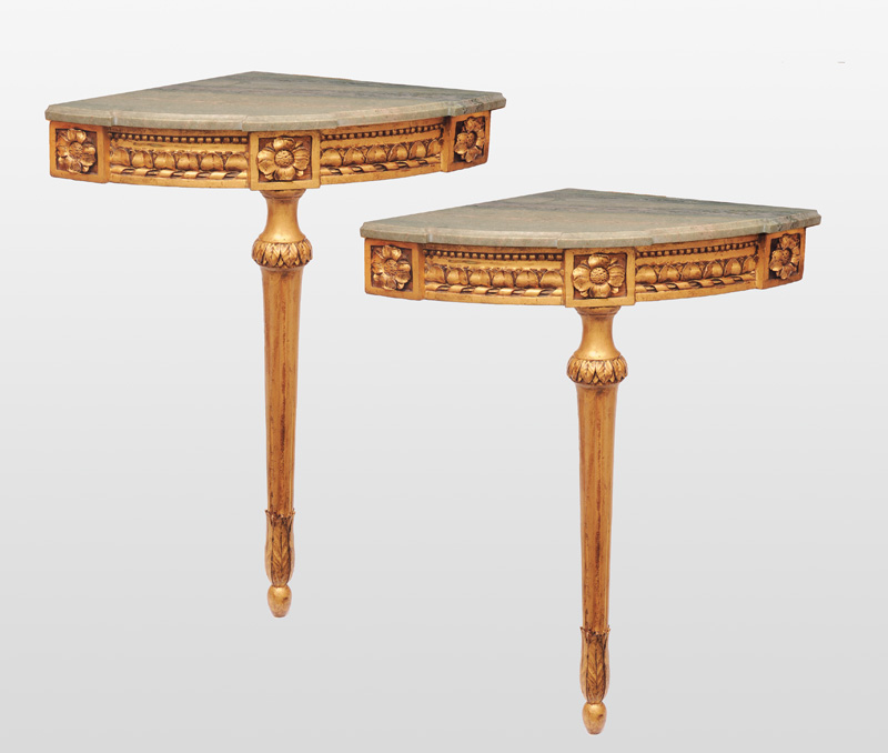 A pair of gilded corner console tables