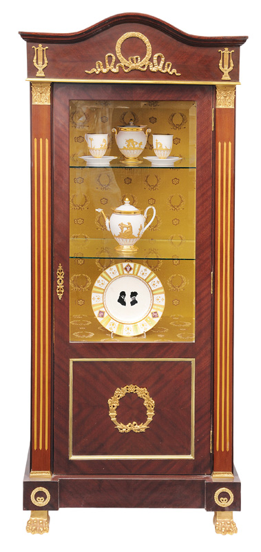 An elegant glass cabinet in the style of Empire