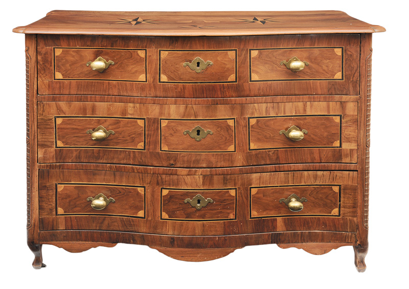 A Baroque chest of drawer with star-shaped inlays and carvings
